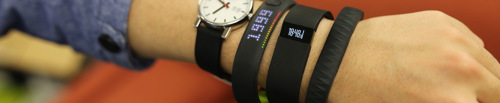 A wrist with a watch and wearable devices